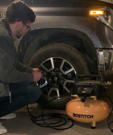 Portable Air Compressor Next to a Truck